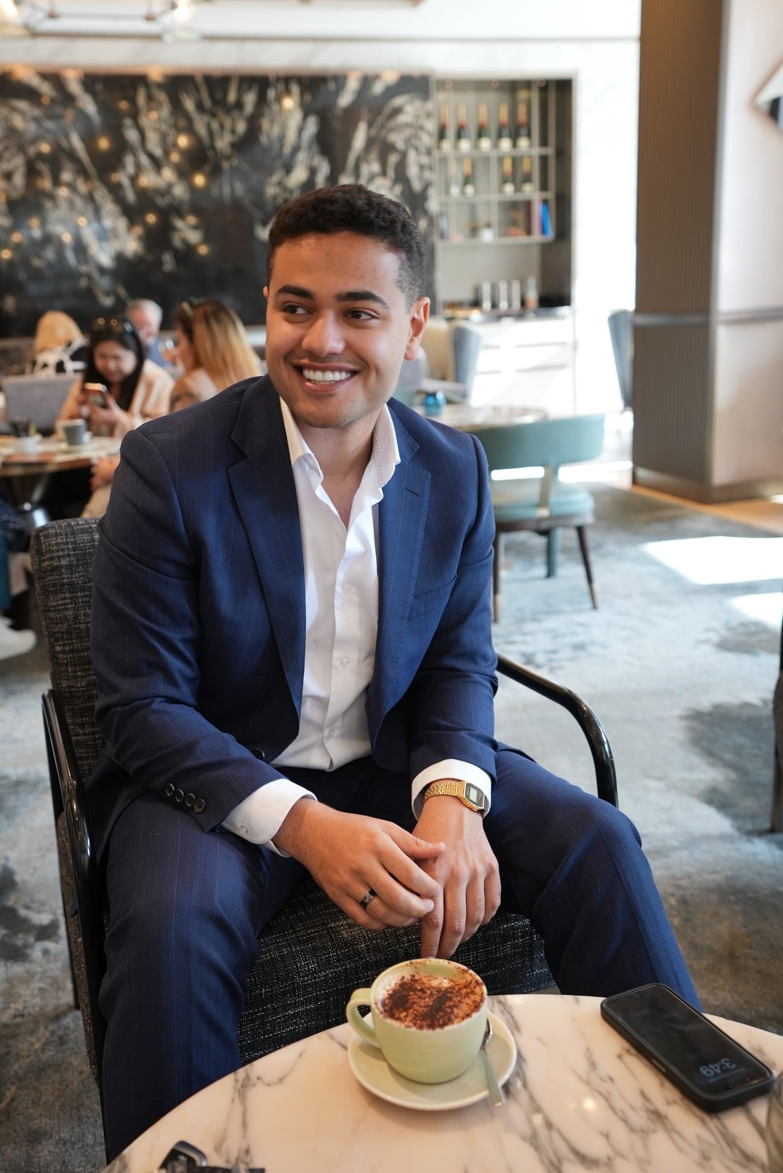Michael Black in conversation, smiling, seated in a Sydney café