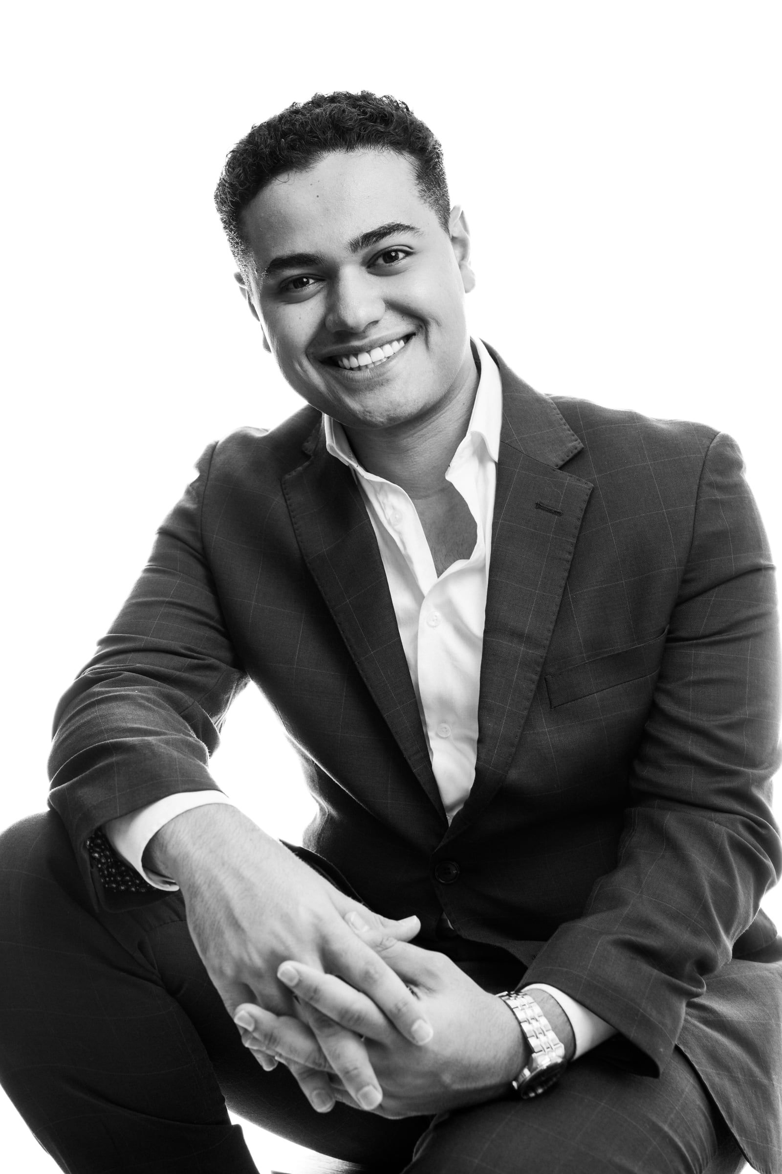 Michael Black, founder and Global CEO of Success Tutoring, smiling in a black-and-white studio portrait