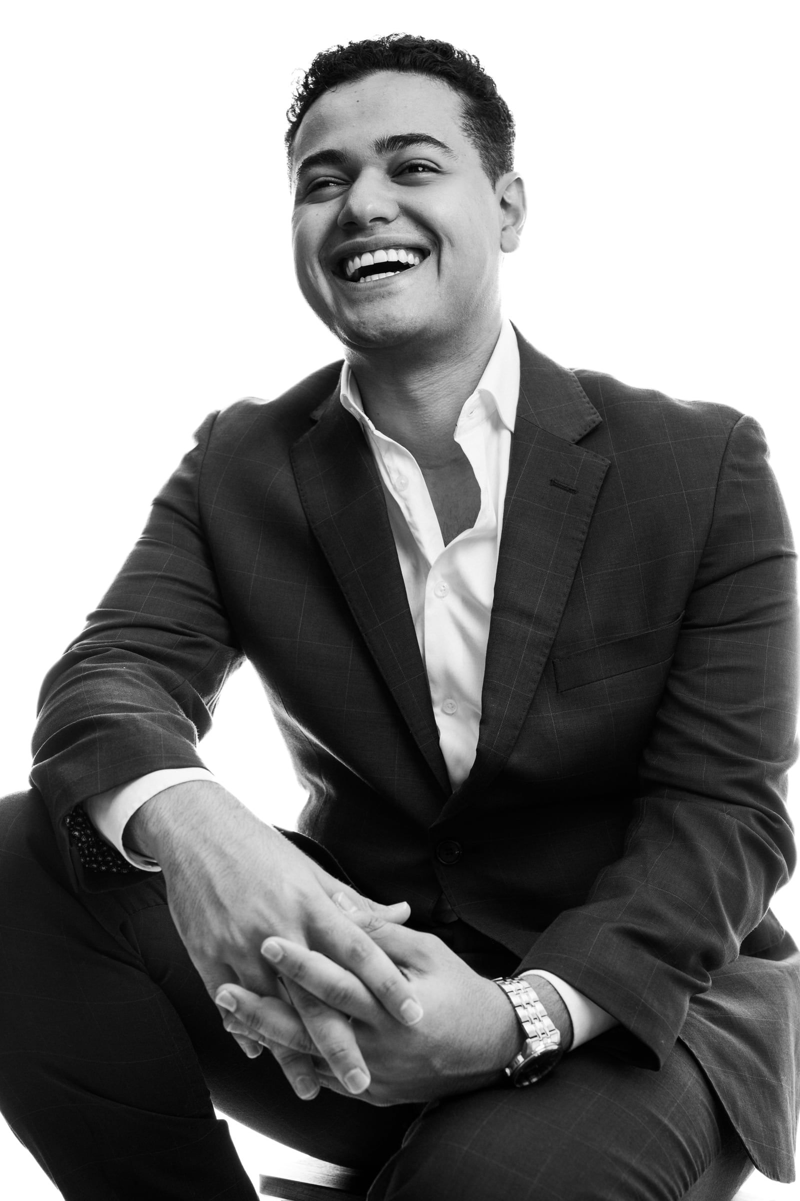 Michael Black laughing in a black-and-white studio portrait