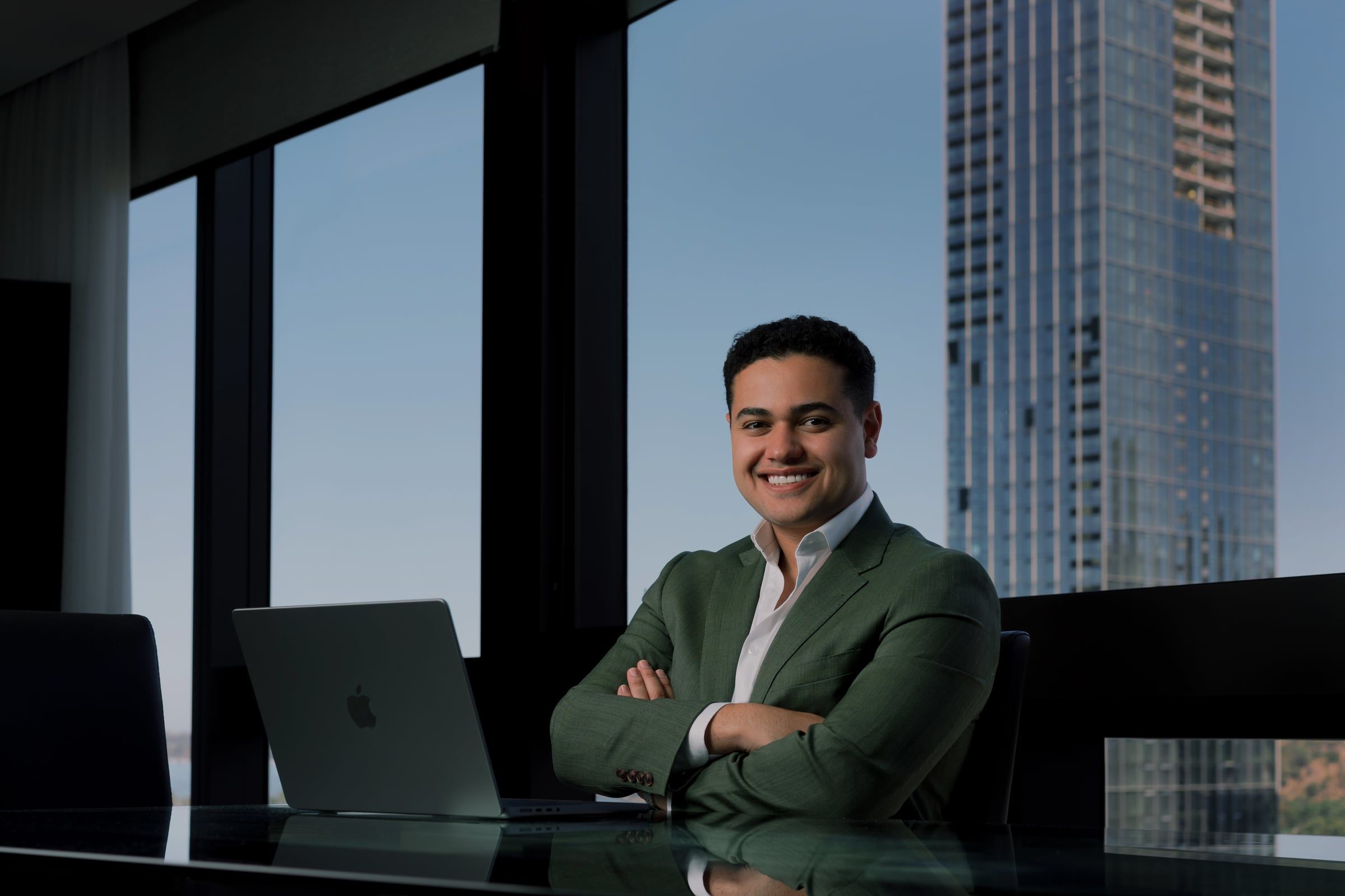 Michael Black at his desk in a Sydney office overlooking the city skyline